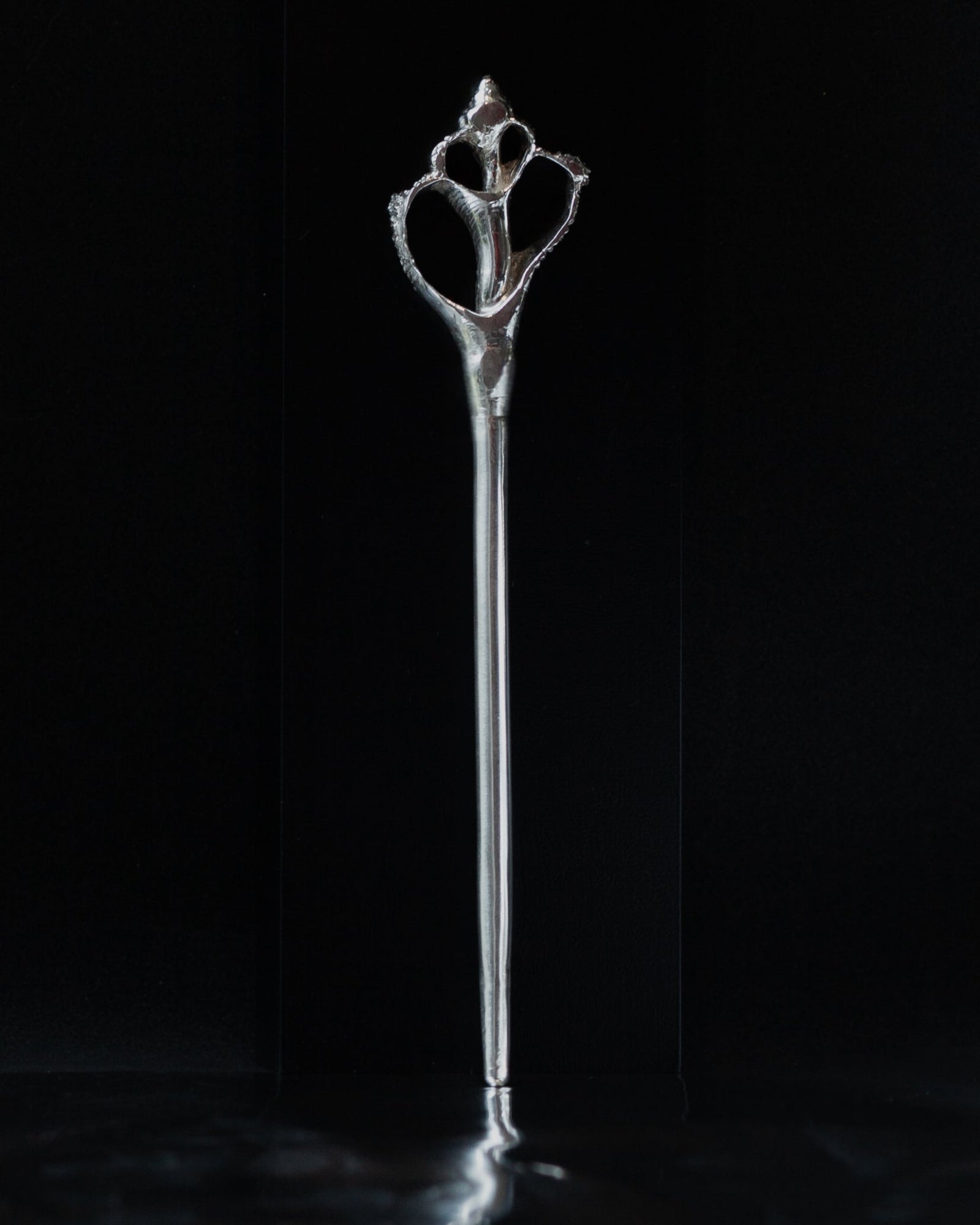 Decorative silver hairpin in see shell pin on a black background