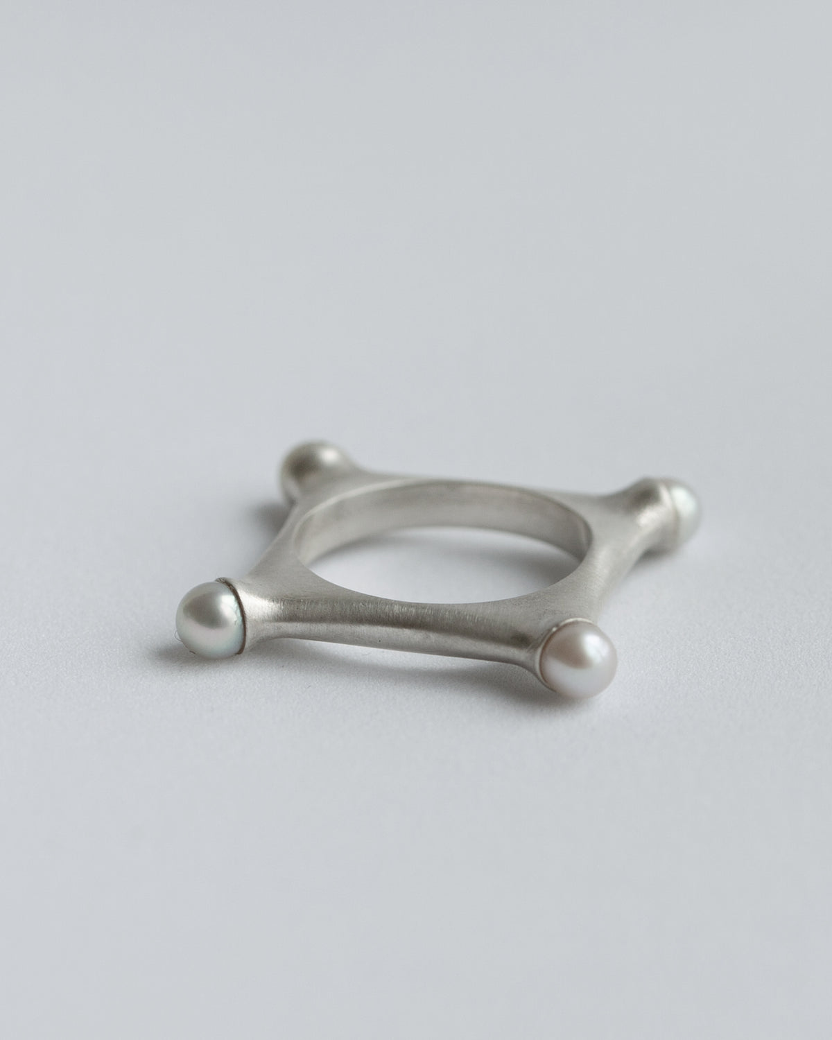 Argentium Silver ring with a pearl on a light gray background